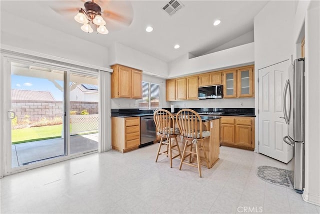2041 Kalliope Ave, Lancaster, CA 93536 - kitchen with appliances with stainless steel finishes, a kitchen bar, vaulted ceiling, dark countertops, and a kitchen island