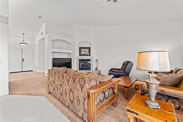 2041 Kalliope Ave, Lancaster, CA 93536 - living area featuring light colored carpet, a tiled fireplace, and built in shelves