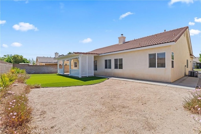 2041 Kalliope Ave, Lancaster, CA 93536 - back of property featuring a chimney, a tile roof, stucco siding, and a patio area