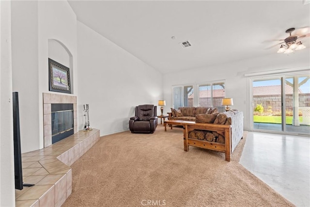 2041 Kalliope Ave, Lancaster, CA 93536 - living area with a tiled fireplace, plenty of natural light, a ceiling fan, carpet floors, and high vaulted ceiling