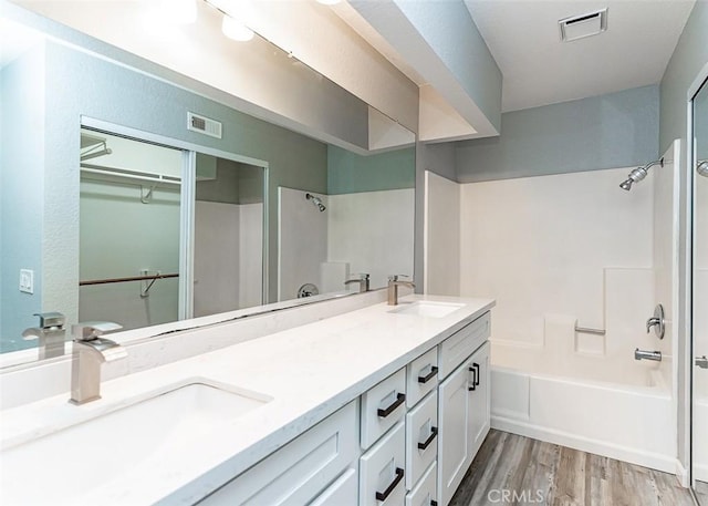 13100 Creek View Dr Unit 204, Garden Grove, CA 92844 - bathroom with double vanity, wood finished floors, shower / washtub combination, and a spacious closet