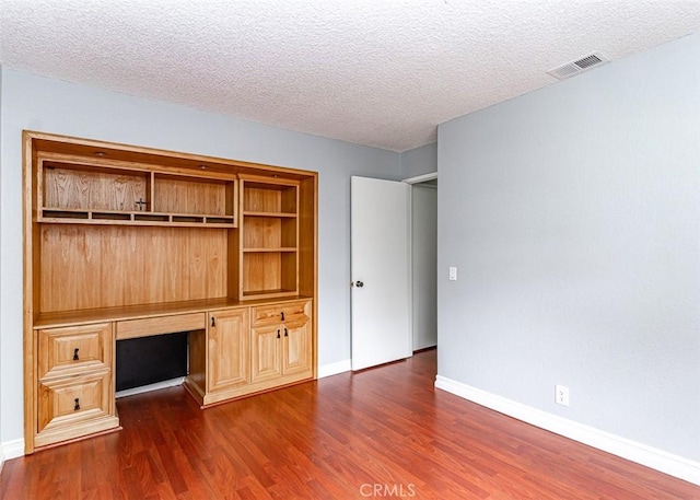 13100 Creek View Dr Unit 204, Garden Grove, CA 92844 - unfurnished office featuring a textured ceiling, built in study area, and dark wood-style floors