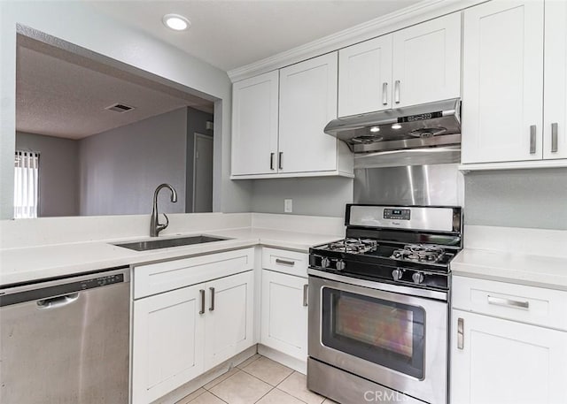13100 Creek View Dr Unit 204, Garden Grove, CA 92844 - kitchen with appliances with stainless steel finishes, under cabinet range hood, light countertops, light tile patterned floors, and white cabinetry