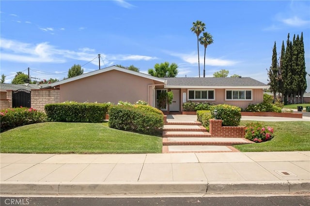 9545 Rubio Ave, Northridge, CA 91343 - ranch-style house with a front yard and stucco siding