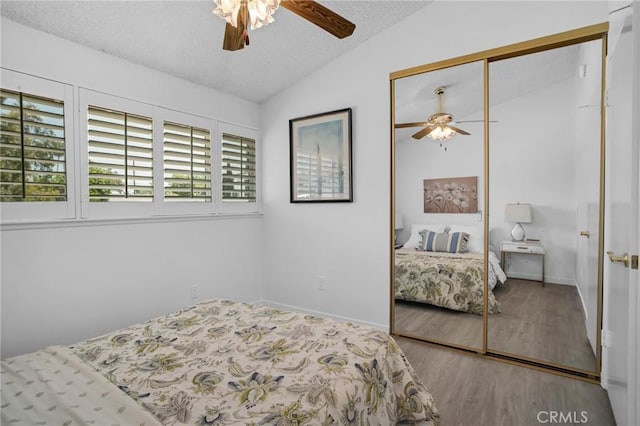 9545 Rubio Ave, Northridge, CA 91343 - bedroom with vaulted ceiling, a closet, a textured ceiling, wood finished floors, and a ceiling fan