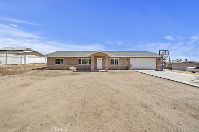 58706 Buena Vista Dr, Yucca Valley, CA 92284 - view of front of property featuring an attached garage, driveway, and stucco siding