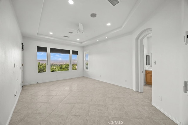 9116 Pinyon Point Ct, Corona, CA 92883 - spare room featuring recessed lighting, a tray ceiling, a ceiling fan, light tile patterned floors, and arched walkways