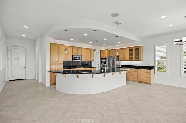 9116 Pinyon Point Ct, Corona, CA 92883 - kitchen with stainless steel appliances, a kitchen breakfast bar, recessed lighting, dark countertops, and glass insert cabinets