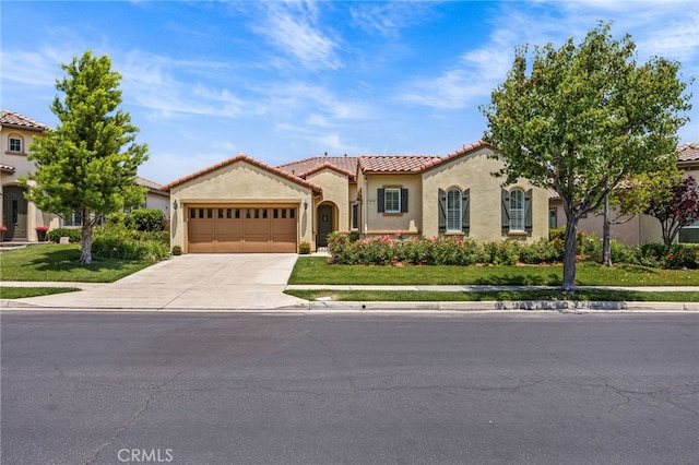 9116 Pinyon Point Ct, Corona, CA 92883 - mediterranean / spanish-style home featuring stucco siding, an attached garage, driveway, a tiled roof, and a front yard