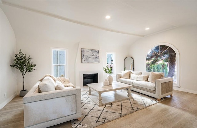 1818 W 79th St, Los Angeles, CA 90047 - living area featuring wood finished floors, vaulted ceiling, a glass covered fireplace, and recessed lighting