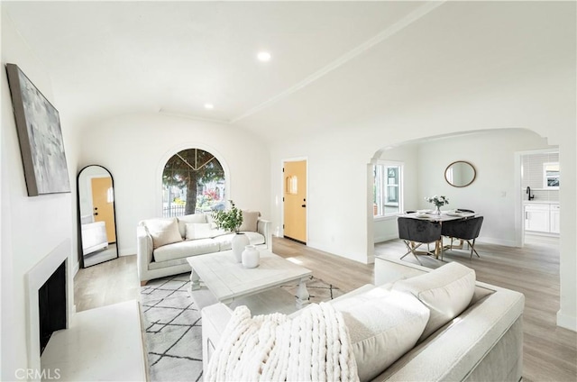 1818 W 79th St, Los Angeles, CA 90047 - living area featuring arched walkways, light wood-style flooring, vaulted ceiling, and recessed lighting