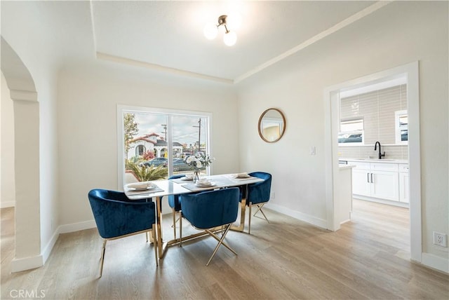 1818 W 79th St, Los Angeles, CA 90047 - dining space featuring light wood-style flooring and arched walkways