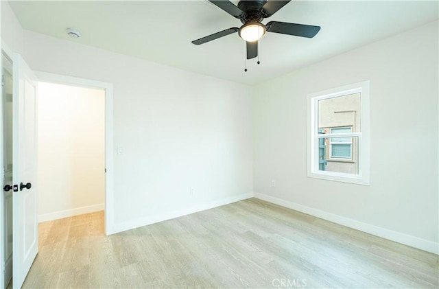 1818 W 79th St, Los Angeles, CA 90047 - empty room featuring light wood finished floors, a smoke detector, and a ceiling fan