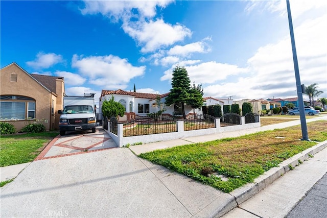 1818 W 79th St, Los Angeles, CA 90047 - view of front facade featuring a fenced front yard, driveway, a residential view, and stucco siding