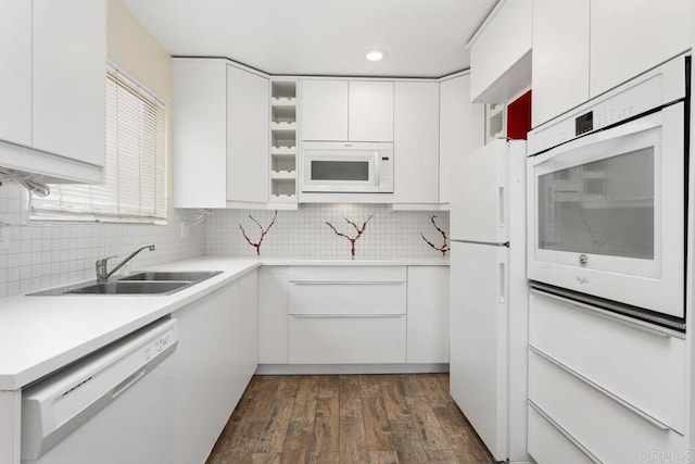 1811 E Grand Ave Unit 162, Escondido, CA 92027 - kitchen with white appliances, white cabinets, dark wood finished floors, tasteful backsplash, and recessed lighting
