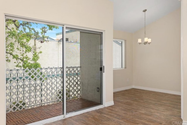 1811 E Grand Ave Unit 162, Escondido, CA 92027 - unfurnished room featuring wood finished floors, lofted ceiling, and a chandelier
