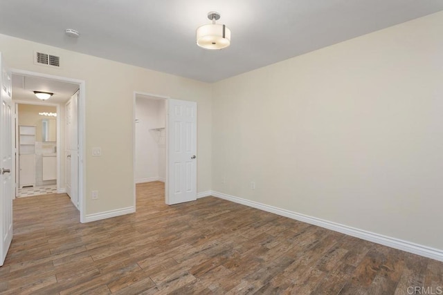1811 E Grand Ave Unit 162, Escondido, CA 92027 - unfurnished bedroom with wood finished floors, a spacious closet, and a closet