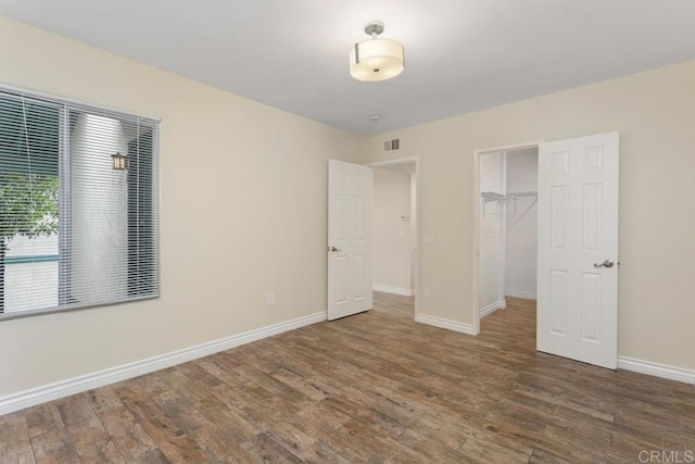 1811 E Grand Ave Unit 162, Escondido, CA 92027 - unfurnished bedroom with wood finished floors, a closet, and a walk in closet