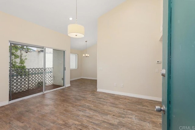 1811 E Grand Ave Unit 162, Escondido, CA 92027 - spare room featuring wood finished floors, a chandelier, and lofted ceiling