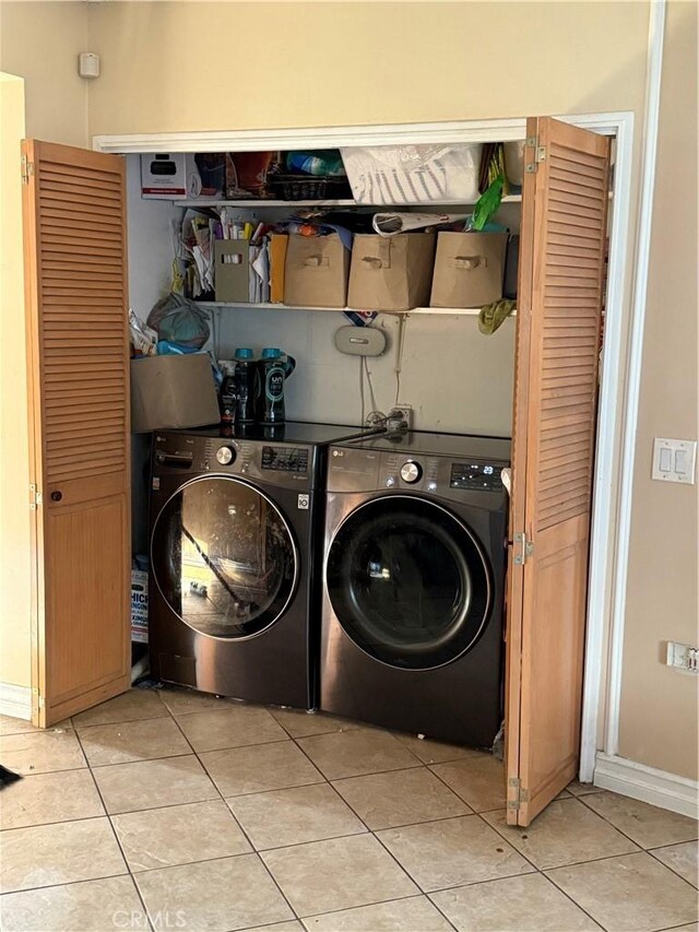 6045 Lincoln Ave, South Gate, CA 90280 - washroom with light tile patterned flooring and washer and dryer