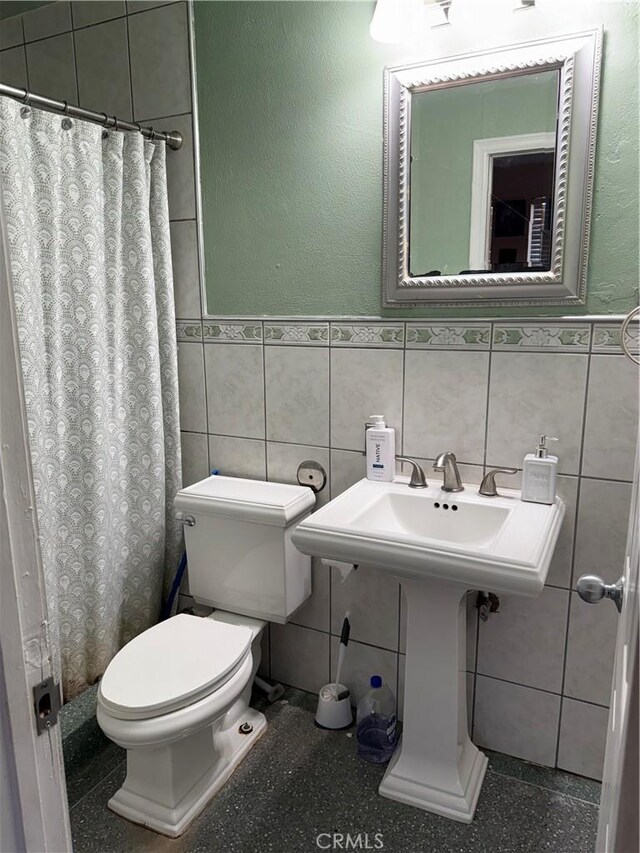 6045 Lincoln Ave, South Gate, CA 90280 - bathroom with a wainscoted wall, tile walls, and a shower with curtain