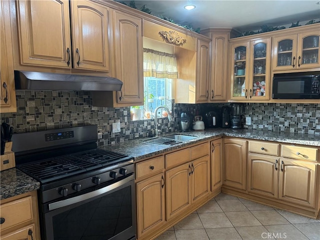6045 Lincoln Ave, South Gate, CA 90280 - kitchen with gas range, black microwave, under cabinet range hood, decorative backsplash, and glass insert cabinets