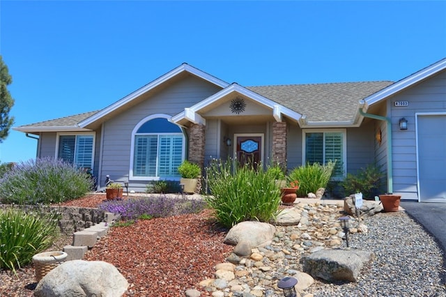 47003 Lookout Mountain Dr, Coarsegold, CA 93614 - single story home with a shingled roof, an attached garage, and stone siding