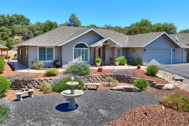 47003 Lookout Mountain Dr, Coarsegold, CA 93614 - ranch-style house with an attached garage, a shingled roof, and asphalt driveway