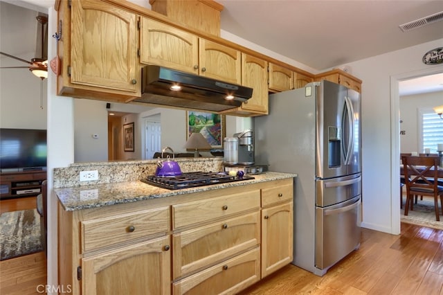 47003 Lookout Mountain Dr, Coarsegold, CA 93614 - kitchen featuring black gas cooktop, under cabinet range hood, stainless steel fridge, light wood-type flooring, and light brown cabinetry