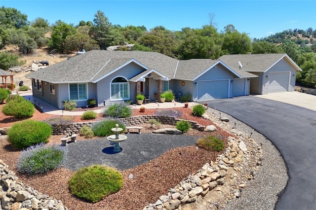 47003 Lookout Mountain Dr, Coarsegold, CA 93614 - single story home with a garage, asphalt driveway, and a shingled roof