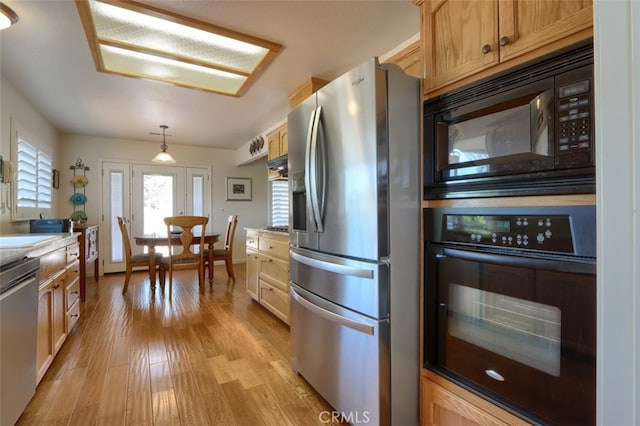 47003 Lookout Mountain Dr, Coarsegold, CA 93614 - kitchen featuring black appliances, light wood finished floors, hanging light fixtures, and light countertops