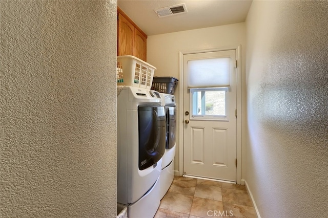 47003 Lookout Mountain Dr, Coarsegold, CA 93614 - laundry room with washing machine and dryer, a textured wall, and cabinet space