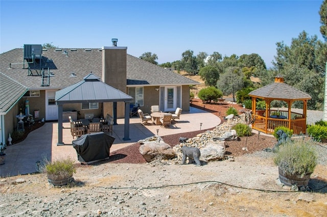 47003 Lookout Mountain Dr, Coarsegold, CA 93614 - rear view of property featuring a gazebo, roof with shingles, a chimney, and a patio