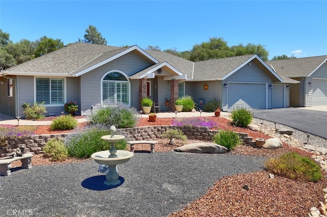 47003 Lookout Mountain Dr, Coarsegold, CA 93614 - ranch-style house with an attached garage, a shingled roof, and driveway