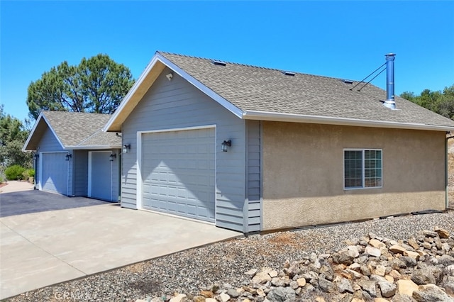 47003 Lookout Mountain Dr, Coarsegold, CA 93614 - view of home's exterior featuring a shingled roof, a garage, and concrete driveway