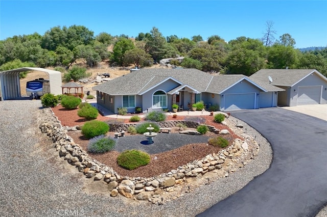 47003 Lookout Mountain Dr, Coarsegold, CA 93614 - ranch-style house with asphalt driveway, an attached garage, a carport, and a shingled roof