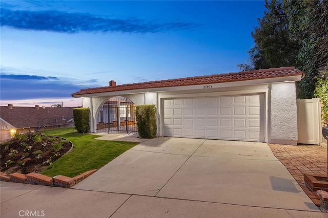 27403 Garza Dr, Saugus, CA 91350 - mediterranean / spanish-style house with stucco siding, a tile roof, driveway, an attached garage, and a front lawn