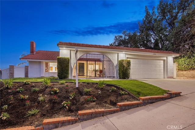 27403 Garza Dr, Saugus, CA 91350 - mediterranean / spanish-style home with concrete driveway, a chimney, a tile roof, an attached garage, and stucco siding