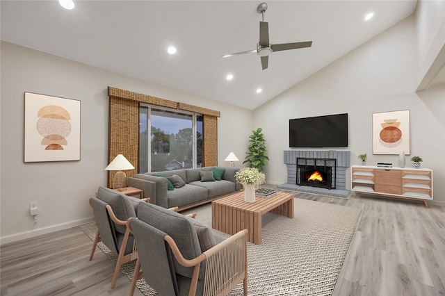 27403 Garza Dr, Saugus, CA 91350 - living room with a fireplace, light wood finished floors, ceiling fan, high vaulted ceiling, and recessed lighting