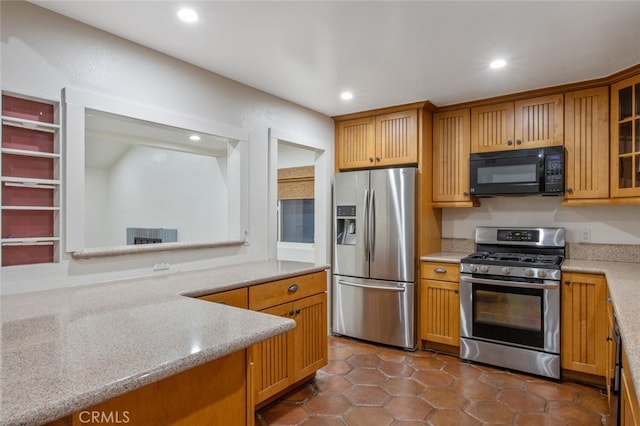 27403 Garza Dr, Saugus, CA 91350 - kitchen with stainless steel appliances, recessed lighting, glass insert cabinets, light stone counters, and dark tile patterned flooring