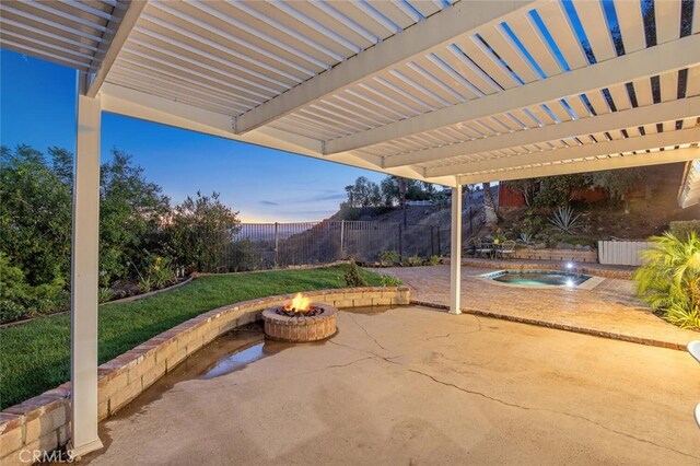 27403 Garza Dr, Saugus, CA 91350 - patio terrace at dusk with an outdoor fire pit, an outdoor hot tub, a patio area, and a fenced backyard
