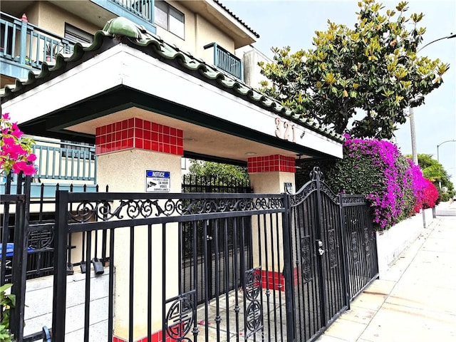 321 N Orange Ave Unit 103, Monterey Park, CA 91755 - view of side of home with a fenced front yard, a gate, and stucco siding