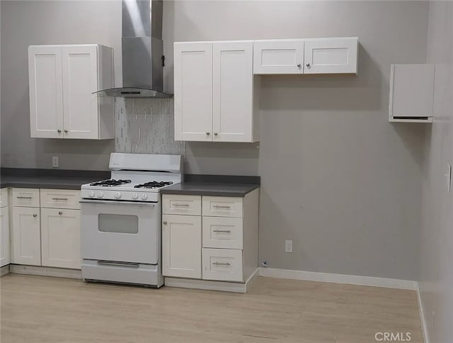 263 S 3rd Ave, Upland, CA 91786 - kitchen with wall chimney exhaust hood, white gas stove, dark countertops, light wood finished floors, and tasteful backsplash