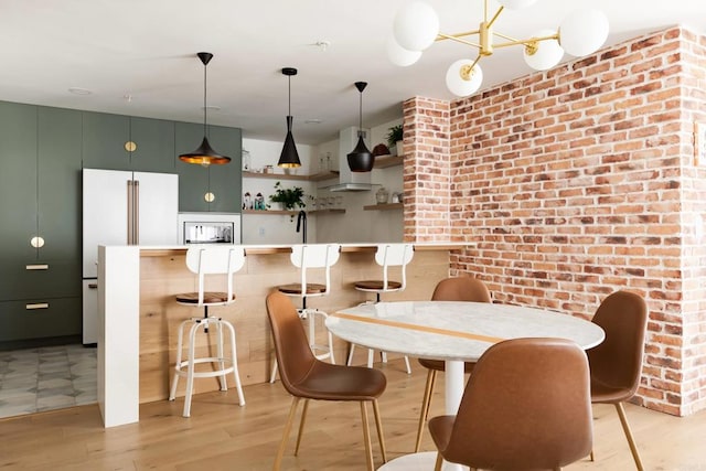 5645 Friars Rd Unit 370, San Diego, CA 92110 - dining space with light wood-type flooring and brick wall