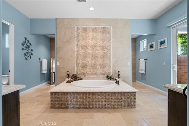 17 Emerald Ct, Rancho Mirage, CA 92270 - bathroom with vanity, a bath, tile walls, tile patterned flooring, and recessed lighting