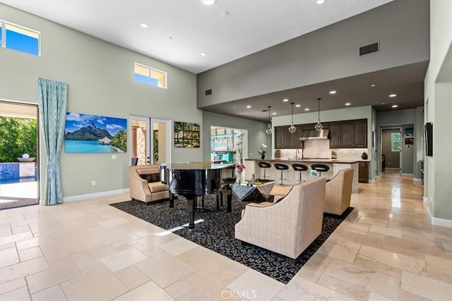 17 Emerald Ct, Rancho Mirage, CA 92270 - living area with a towering ceiling, stone tile flooring, and recessed lighting