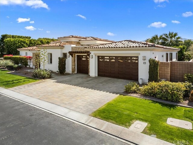 17 Emerald Ct, Rancho Mirage, CA 92270 - mediterranean / spanish house with stucco siding, an attached garage, a tiled roof, and decorative driveway