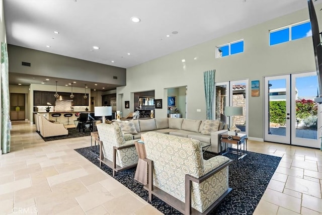 17 Emerald Ct, Rancho Mirage, CA 92270 - living room with a high ceiling, recessed lighting, french doors, and stone tile flooring