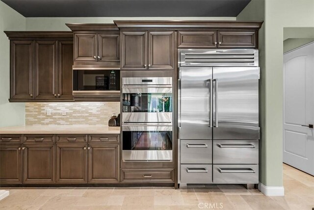 17 Emerald Ct, Rancho Mirage, CA 92270 - kitchen featuring built in appliances, dark brown cabinetry, backsplash, and light countertops