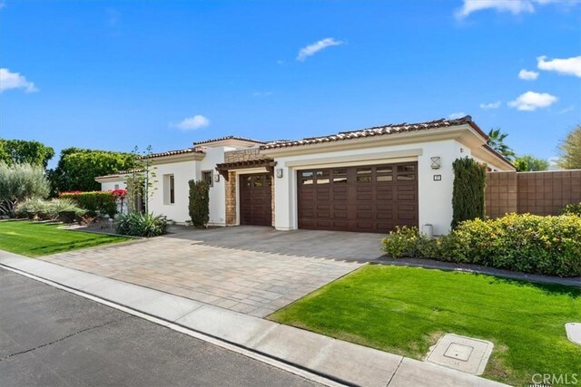 17 Emerald Ct, Rancho Mirage, CA 92270 - mediterranean / spanish-style house featuring stucco siding, decorative driveway, a garage, and a tile roof